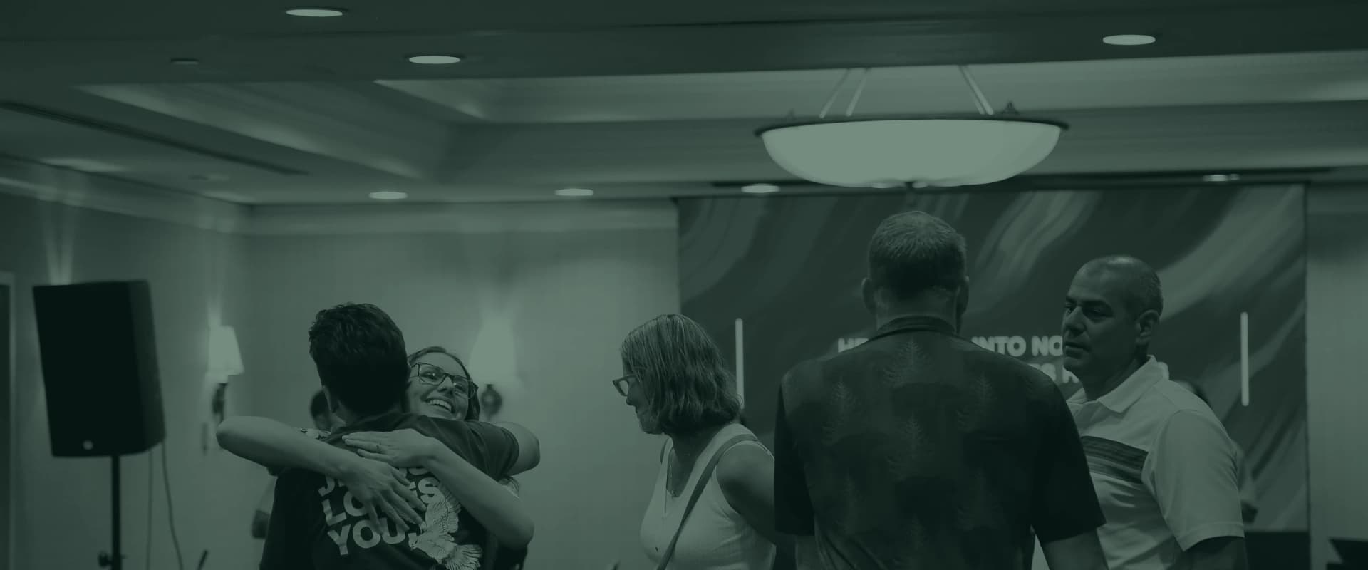 Two people hugging in the room after the service
